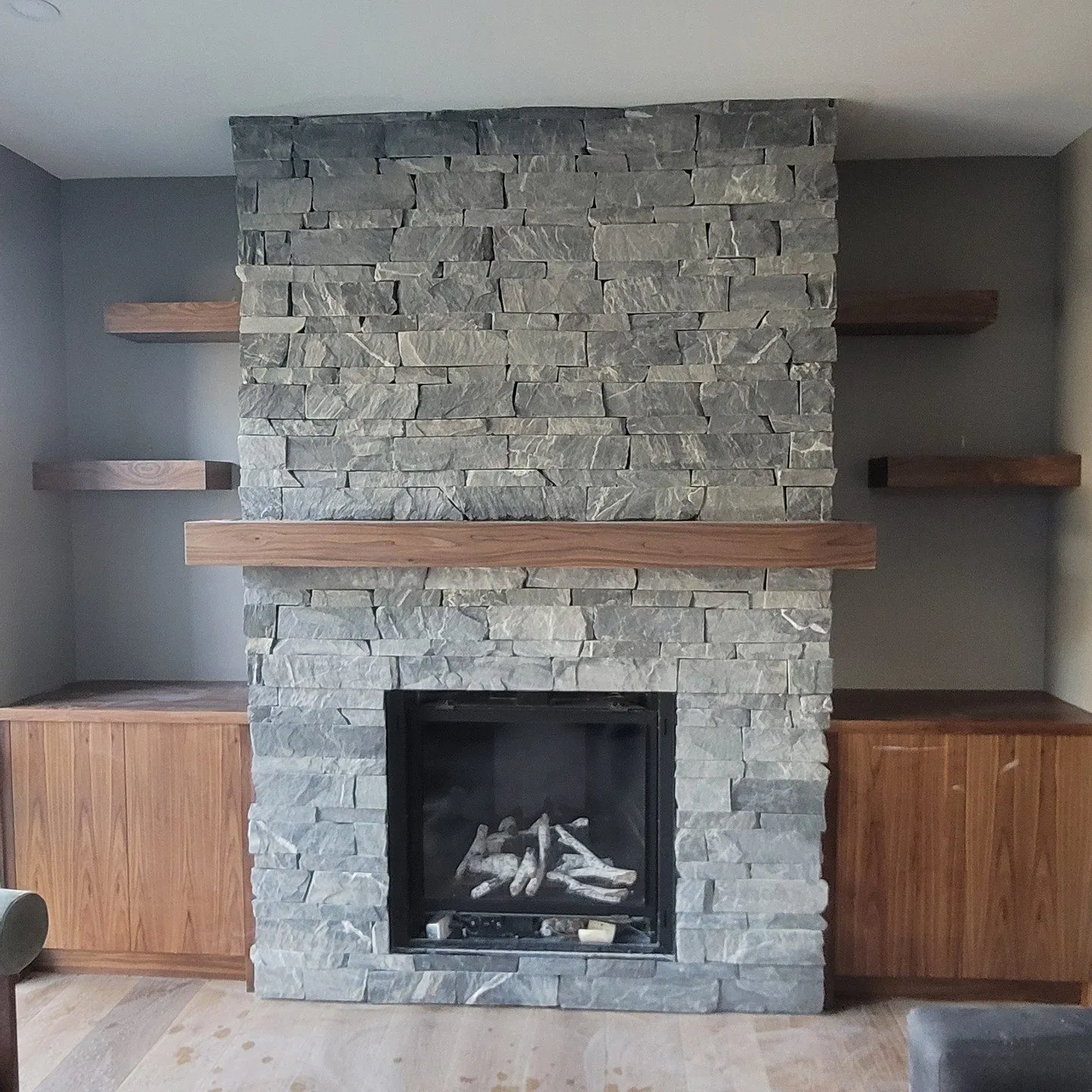 A stone fireplace wall mid-craft